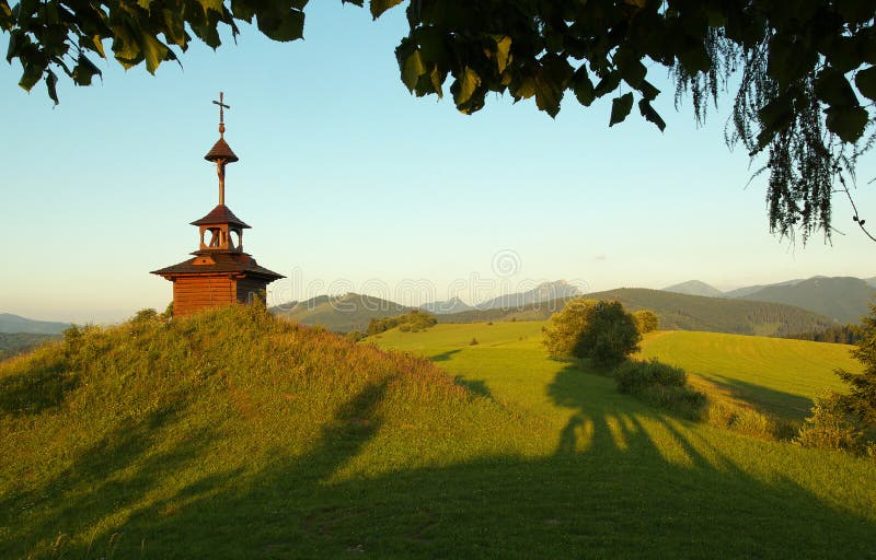 View of a meadow with a small chapel