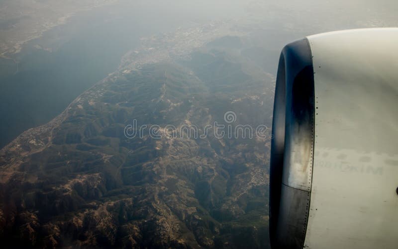 View of the mountains from the plane window. View from a height. Earth and sky through the airplane window. Airplane height stock images, royalty-free photos and pictures