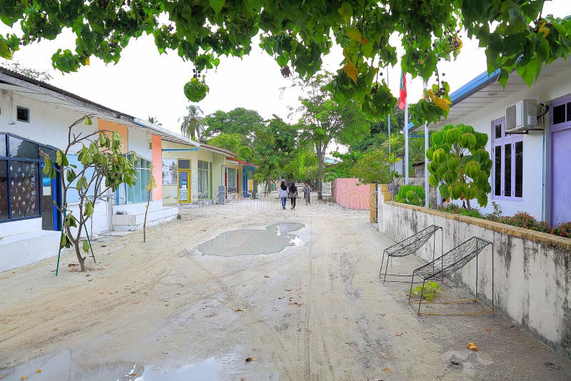 View of narrow street in a poor local village on Maldives, Dhangethi Island. White sand and grey walls royalty free stock photo View of narrow street in a poor local village on Maldives, Dhangethi Island. White sand and grey walls royalty free stock photo