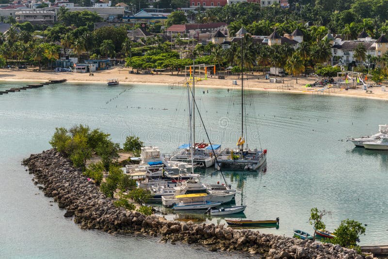 View of Ocho Rios Bay Beach and marina in Jamaica. Ocho Rios, Jamaica - April 22, 2019: Coastline view with Ocho Rios Bay Beach and marina, in the tropical stock image View of Ocho Rios Bay Beach and marina in Jamaica. Ocho Rios, Jamaica - April 22, 2019: Coastline view with Ocho Rios Bay Beach and marina, in the tropical stock image