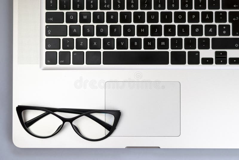 Desk with laptop, glasses and other items stock images Desk with laptop, glasses and other items stock images