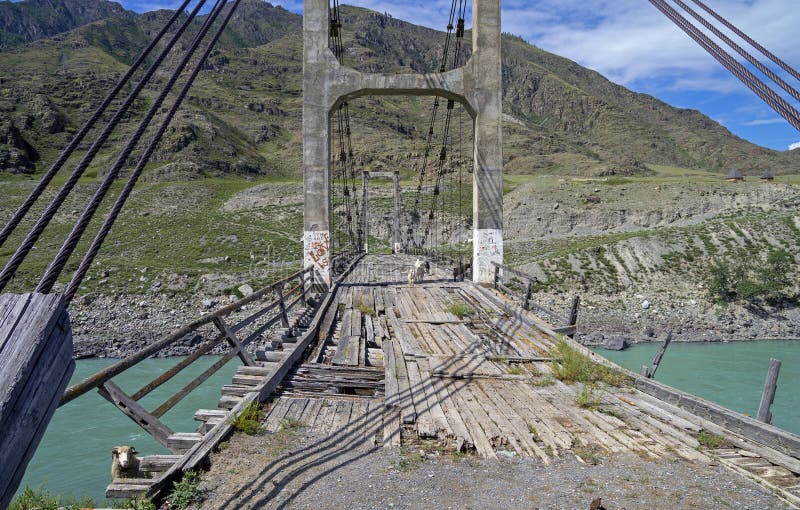 View through the old bridge over mountain river.