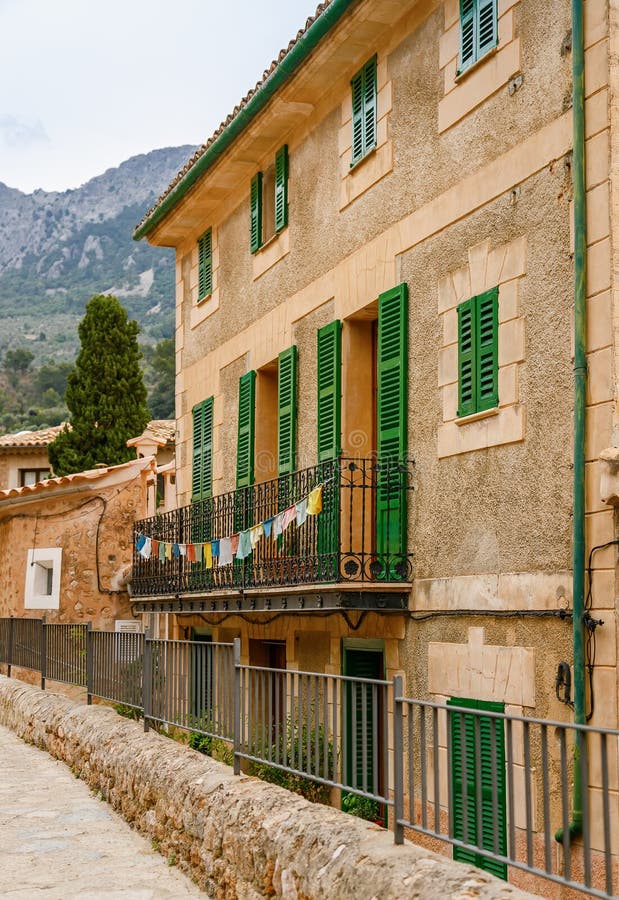 View of the old house with drying clothes on a balcony in the small village Fornalutx