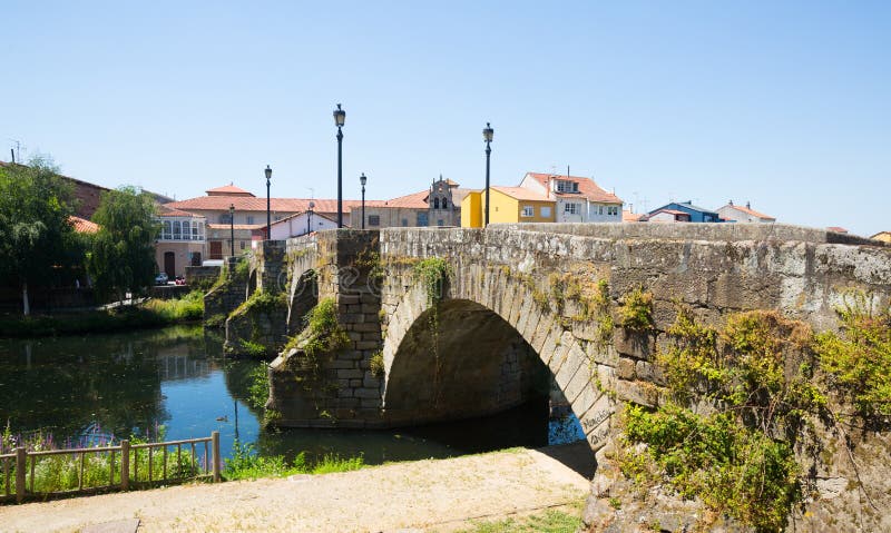 View of old stone bridge at Monforte de Lemos in sunny day. Galicia, Spain