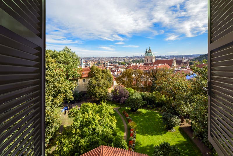 View through an open window near the Prague Castle of the city, complex and St Nichols Church in Prague, Czechia royalty free stock image View through an open window near the Prague Castle of the city, complex and St Nichols Church in Prague, Czechia royalty free stock image