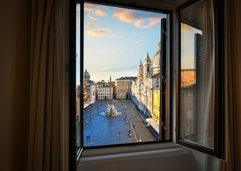 View from an open window overlooking the Piazza Navona at sunrise showing Bernini`s Fountain of Four Rivers stock photos View from an open window overlooking the Piazza Navona at sunrise showing Bernini`s Fountain of Four Rivers stock photos
