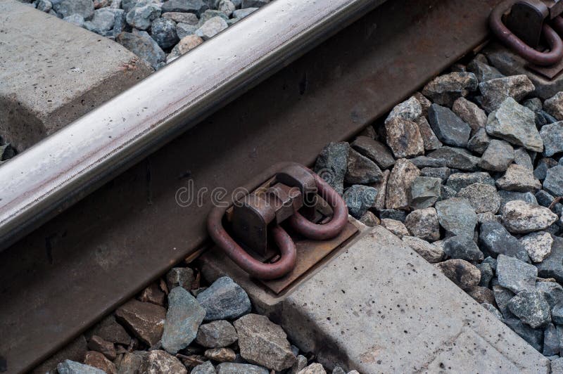 View on the option of fastening the rails to the concrete base on the railway. stock images View on the option of fastening the rails to the concrete base on the railway. stock images