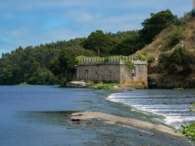 View over River Ave in Portugal to old stone castle ruin on the river bank royalty free stock photos View over River Ave in Portugal to old stone castle ruin on the river bank royalty free stock photos