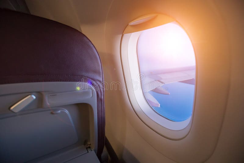 View from passenger`s seat in airplane flying above clouds in dr stock photo View from passenger`s seat in airplane flying above clouds in dr stock photo