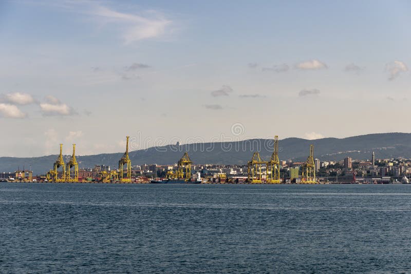 View of Pier VII of the Port of Trieste with cranes for loading:unloading containers stock image