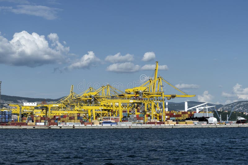 View of Pier VII of the Port of Trieste with cranes for loading:unloading containers stock image