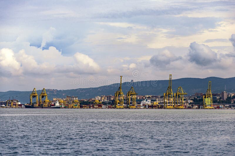 View of Pier VII of the Port of Trieste with cranes for loading:unloading containers stock photography