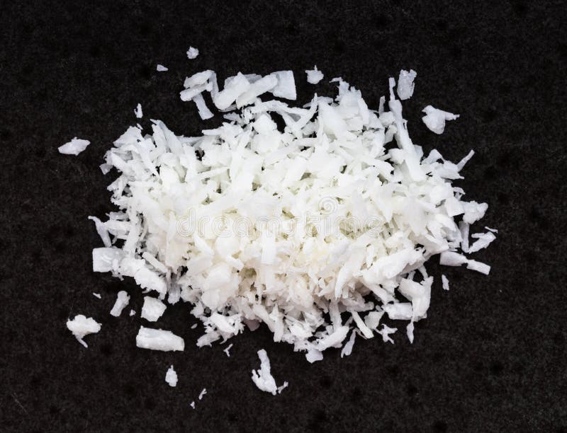 View of pile of coconut flakes close up on black stock photography