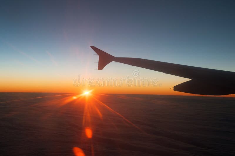 View from the plane on a beautiful orange sunset stock photo