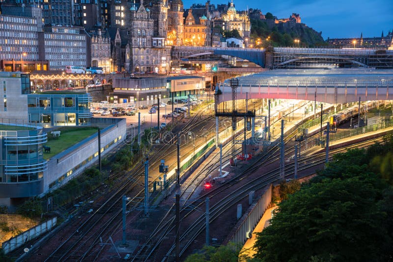 View of railway tracks near a train station at dusk stock photos View of railway tracks near a train station at dusk stock photos