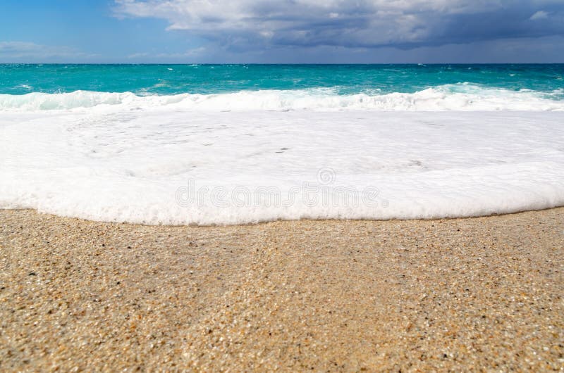 Turquoise water on the Riaci beach near Tropea, Italy. View from Riaci beach on the turquoise water waves, cloudy sky and horizon over water. This beach is stock images Turquoise water on the Riaci beach near Tropea, Italy. View from Riaci beach on the turquoise water waves, cloudy sky and horizon over water. This beach is stock images