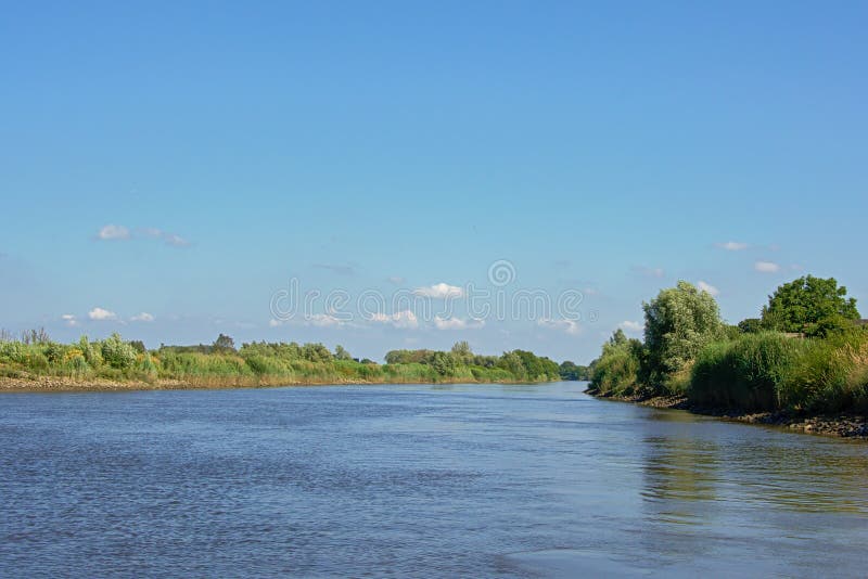 View on river Scheldt from a above the water. View on river Scheldt with green natural borders from a boat in Schellebelle, Flanders, Belgium stock photography View on river Scheldt from a above the water. View on river Scheldt with green natural borders from a boat in Schellebelle, Flanders, Belgium stock photography