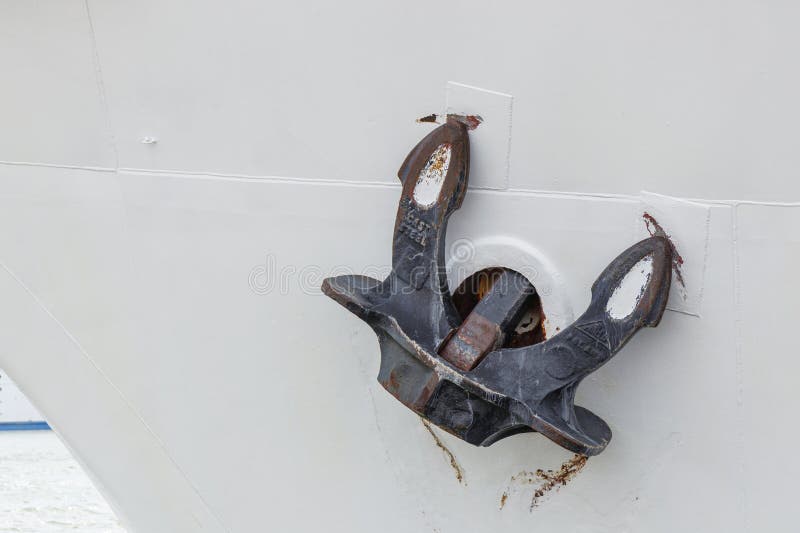 View of a rusted ship's anchor on the anchor hole of a white ship on the Baltic Sea stock photography