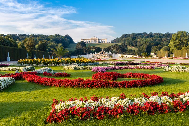 View on Schonbrunn Palace and garden with colorful flowers, Austrian flag made of flowers