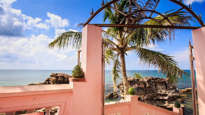 View of Sea Stones Palm through Arch Gate Leading to Beach