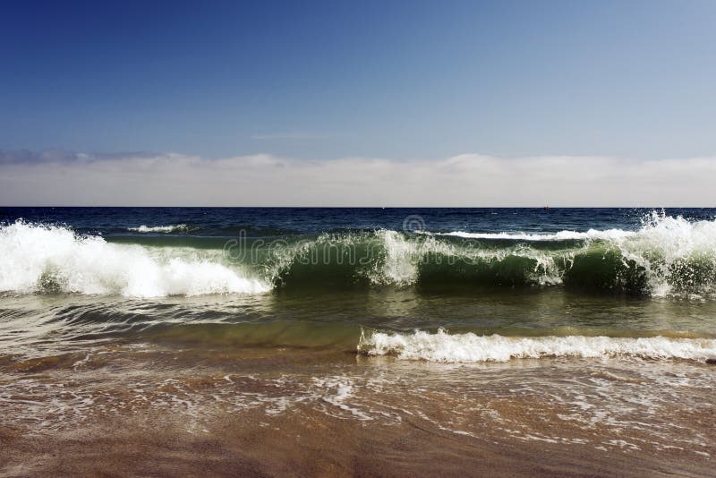 A view of a seascape, Pacific ocean, waves and foams and splash in Malibu, California.  royalty free stock photo