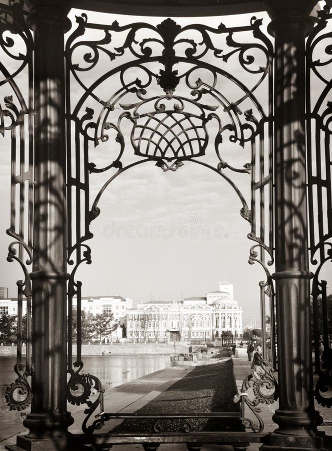 View of the Sevastianov's mansion through beautiful carved wrought iron bars, Ekaterinburg royalty free stock images View of the Sevastianov's mansion through beautiful carved wrought iron bars, Ekaterinburg royalty free stock images