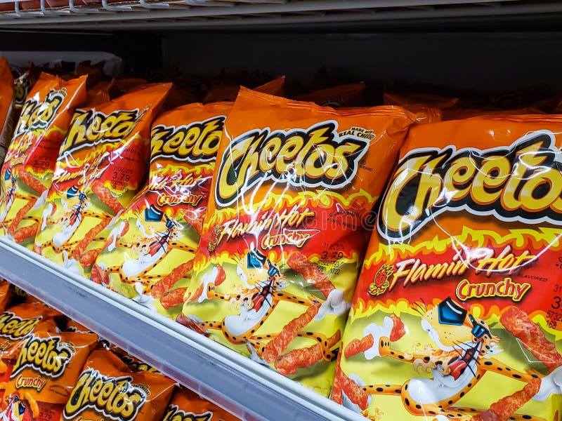 Cheetos hot. A view of several bags of Cheetos Flamin` Hot Crunchy chips, on display at a local grocery store stock photos Cheetos hot. A view of several bags of Cheetos Flamin` Hot Crunchy chips, on display at a local grocery store stock photos