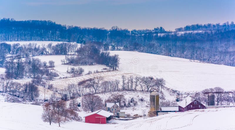 View of snow-covered farm fields and rolling hills in rural York