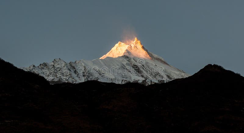 View of snow covered peak of Mount Manaslu during sunrise 8 156 meters with clouds in Himalayas, sunny day at Manaslu Glacier