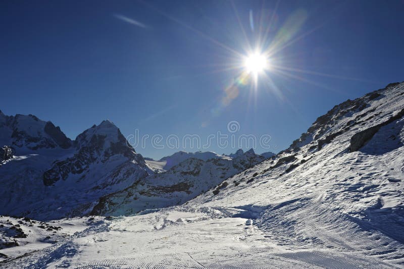 View of snow mountains and ski slope in Switzerland Europe on a cold sunny day