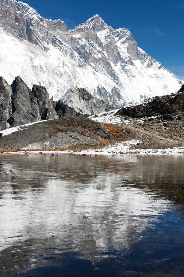 View of southern face of lhotse and nuptse mirroring on the lake on the way to everest base camp