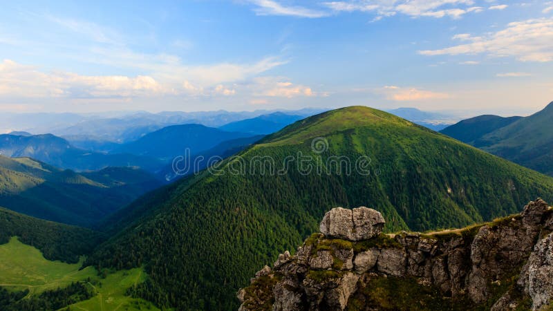 View of Stoh, Mala Fatra during sunset. Prominent mountain with small rock in the foreground