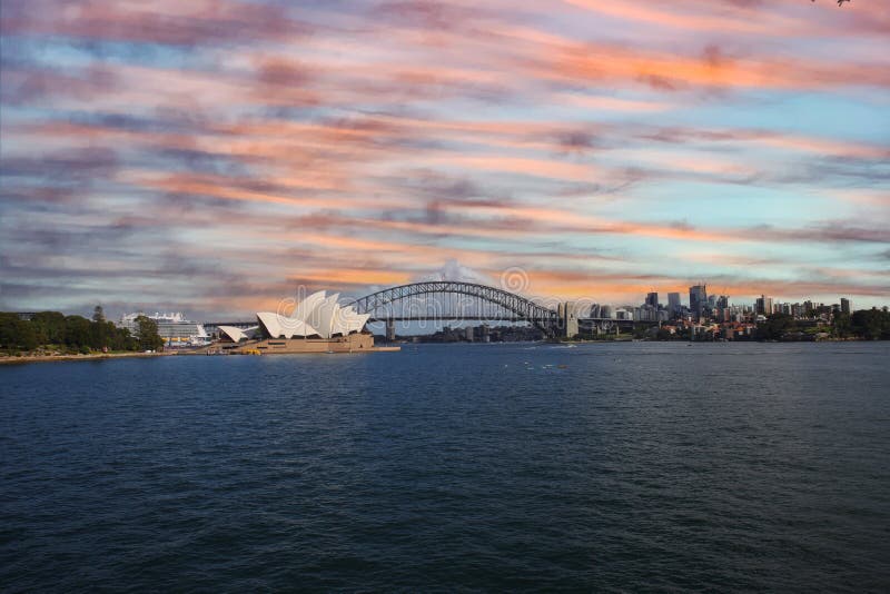 View of Sydney Harbour NSW Australia. Ferry boats partly cloudy colourful skies blue waters