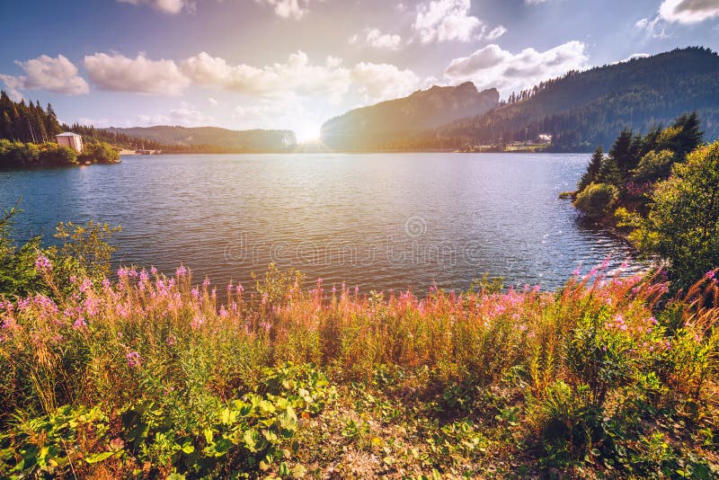 View to Bolboci lake and the damb with carpathian mountains at t