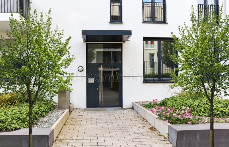 View to entrance door of a modern residential building with new apartments in the city