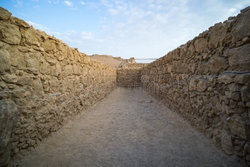 View to old stone blind alley. Architecture of ancient civilization. Masada paths and passages, Israel. Labyrinth dead-end. royalty free stock photos View to old stone blind alley. Architecture of ancient civilization. Masada paths and passages, Israel. Labyrinth dead-end. royalty free stock photos