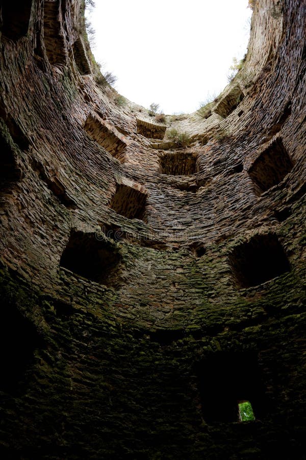 View to the sky inside the old ruined castle tower without a roof