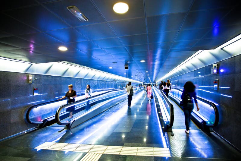 View to wide blue corridor with escalators