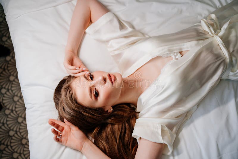 Beautiful young sensuality pretty Asian woman wearing red bra sleeping and  make happy smile on the white bed at bedroom in the morning. Stock Photo