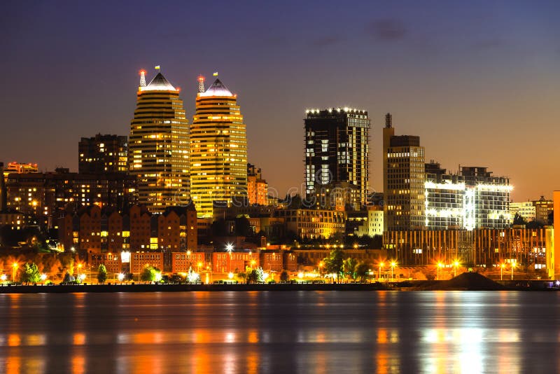 View of the towers, skyscrapers and buildings in Dnepr city at night, lights reflected on the river Dnieper, Ukraine. stock image View of the towers, skyscrapers and buildings in Dnepr city at night, lights reflected on the river Dnieper, Ukraine. stock image