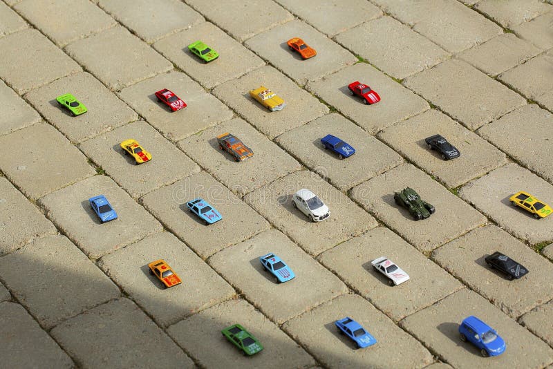 View of toy cars models carefully put each on it`s place by child. Children concept. royalty free stock image View of toy cars models carefully put each on it`s place by child. Children concept. royalty free stock image