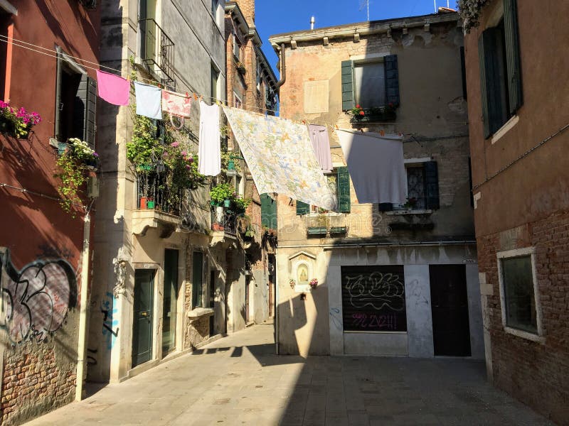 A view of a traditional neighbourhood in Venice, Italy with old historic buildings and laundry being dried