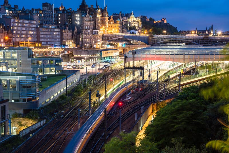 View of a train in motion leaving a train station at night royalty free stock photos View of a train in motion leaving a train station at night royalty free stock photos
