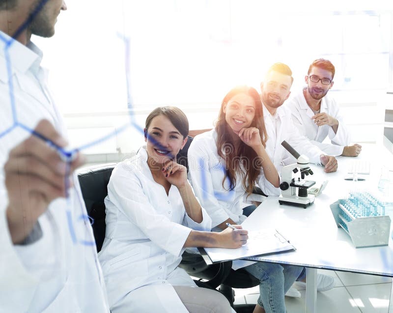 View through the transparent Board. a scientist makes a report. royalty free stock photography View through the transparent Board. a scientist makes a report. royalty free stock photography
