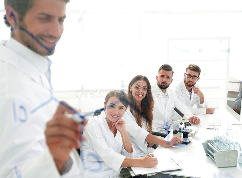 View through the transparent Board. a scientist makes a report. stock photo View through the transparent Board. a scientist makes a report. stock photo