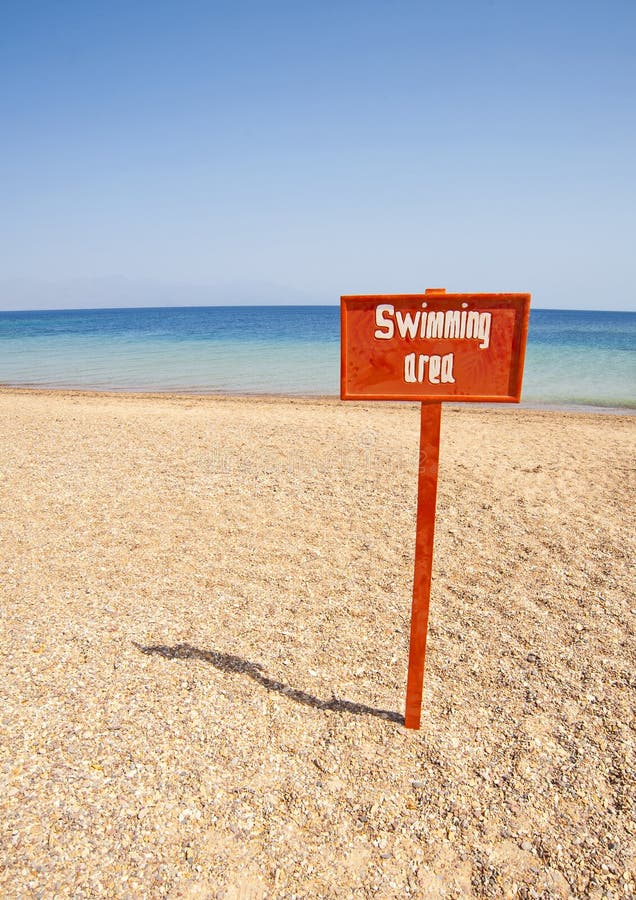 View from a tropical beach with swimming sign