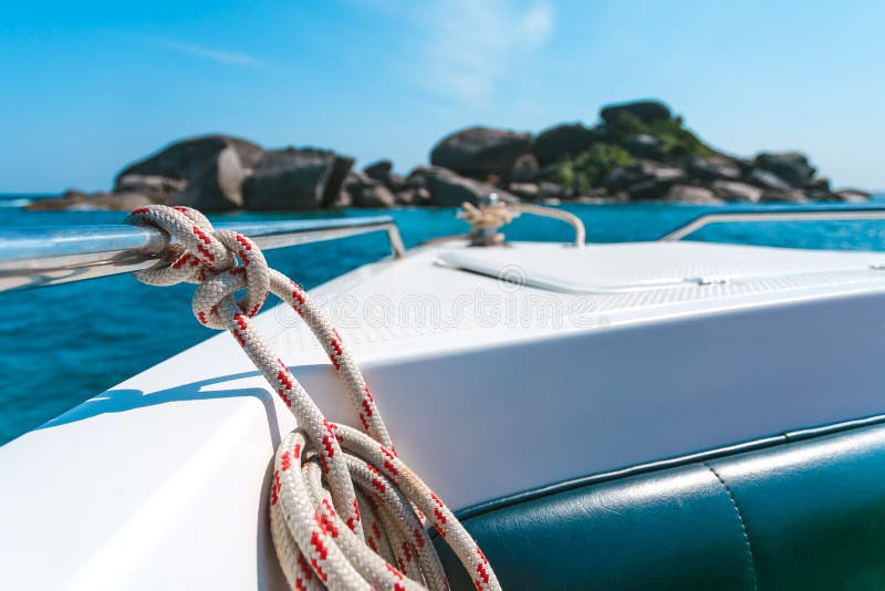 View of tropical sea from yacht or boat, anchor rope tied, clear water and stone beautiful like a heaven