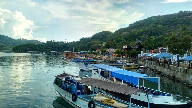 the view in the village at the end of Labuan Bajo on the pier, it looks like a fishing boat is leaning on