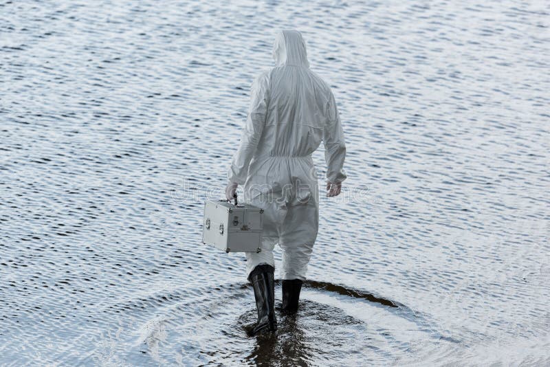 Length View Of Water Inspector In Protective Suit Holding Inspection