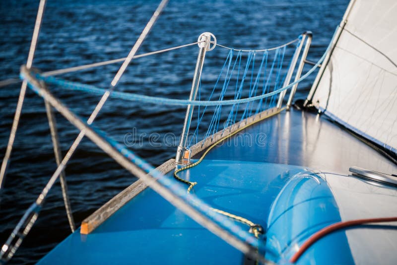 View of Waves from through Rope Railing of a Keeling Sailboat. Stock